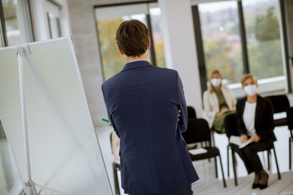 business people with protective facial masks on education forum
